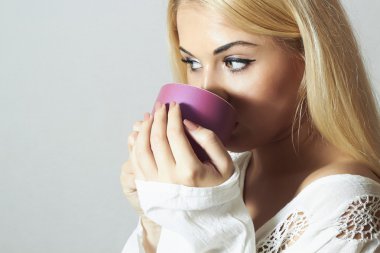 Beautiful blond woman drinking Coffee. Cup of tea. Hot drink. Morning clipart