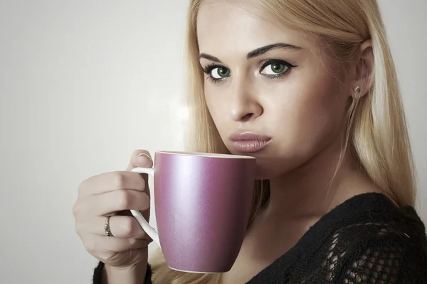 Mulher loira bonita bebendo café. Uma xícara de chá. Bebida quente — Fotografia de Stock