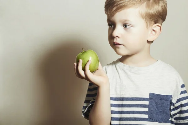 Child holds the apple.Little Handsome Boy with green apple. Health food. Fruits. Enjoy Meal — Stock Photo, Image