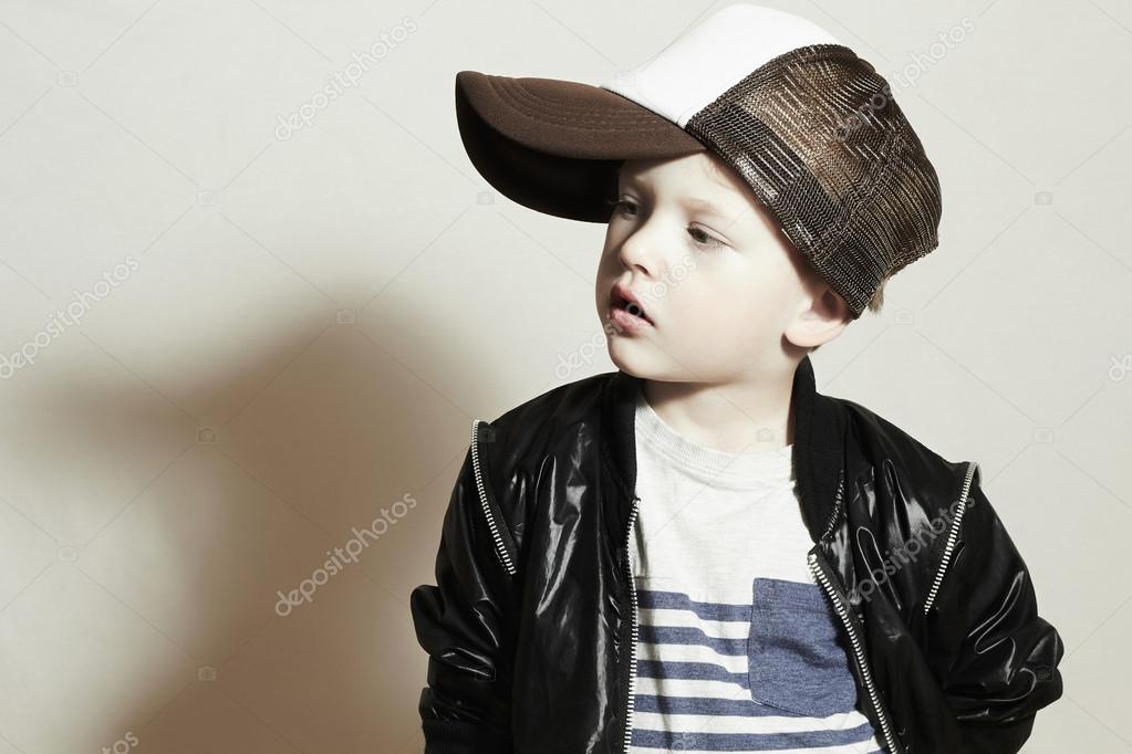 Hip Hop Style Fashion Children Handsome Blond Kid With Big Blue Eyes Pose Boy In Tracker Hat Young Rapper Funny Child In Cap Hip Hop Style Fashion Children Handsome Blond Kid With Big Blue Eyes Pose Boy In Tracker Hat Young Rapper Funny Child In Cap