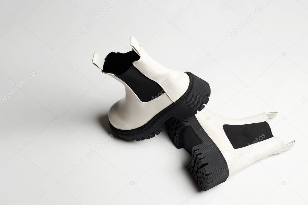 White Trendy boots. fashion female shoes still life. stylish chelsea boots