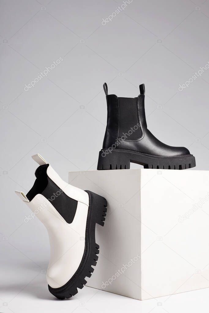 black and white boots. fashion shoes still life. stylish photo in the studio