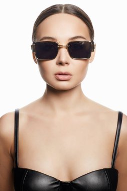 fashion portrait of Beautiful woman in sunglasses and leather underwear. beauty girl in trendy Glasses