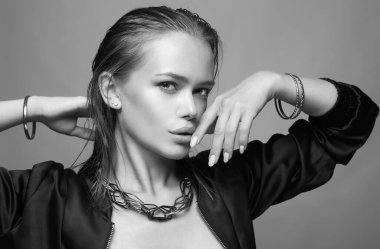 black and white portrait of beautiful girl with jewelry. young wet hair style woman with accessories