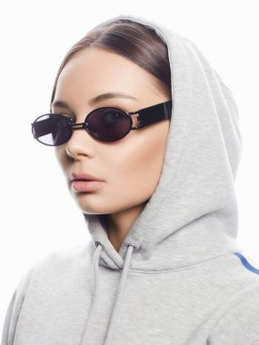 fashion portrait of Beautiful woman in sunglasses and hood. beauty girl in trendy Glasses