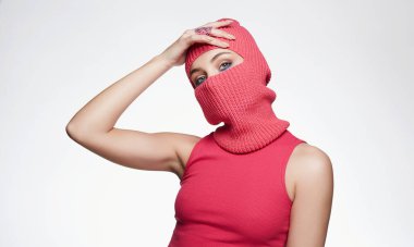 beautiful girl in red balaclava. Trendy Pink Mask on pretty woman