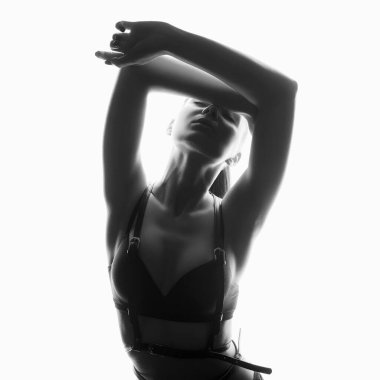 black and white portrait of Beautiful woman in leather belt and underwear. sexy girl iin white lights