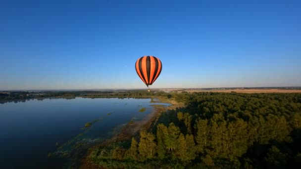 Drone Orbiting Close Black Orange Hot Air Balloon Reveal Sunshine — Wideo stockowe