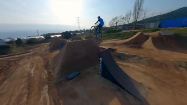 Dynamic Fpv Drone Shot Bike Rider Hits Big Dirt Jumps — Vídeos de Stock