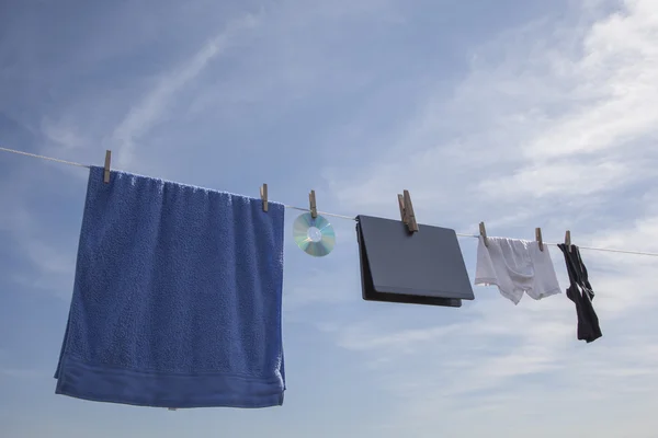 Laptop CD And Clothes On The Clothesline — Stock Photo, Image