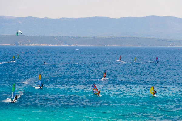 Watercolor drawing of Windsurfers on water of Bol gulf Brac island in front of Hvar island, Adriatic sea, Croatia