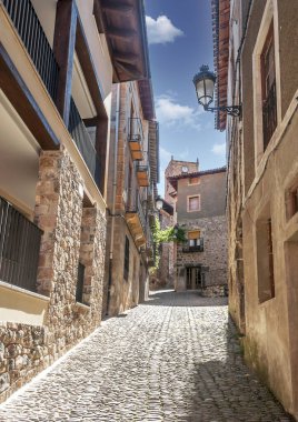 Street of Vinuesa a rural town of the province of Soria in Spain on a sunny day. clipart