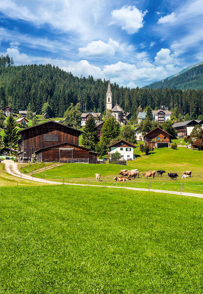 Village of Gosau with its wooden houses in the Alps of Austria on a cloudy day.
