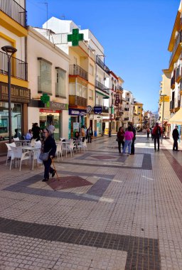 RONDA SPAIN - MAY 2022. Tourist walking in the shop street of Ronda in a sunny day. 