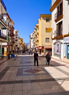 RONDA SPAIN - MAY 2022. Tourist walking in the shop street of Ronda in a sunny day. 