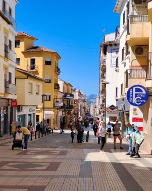RONDA SPAIN - MAY 2022. Tourist walking in the shop street of Ronda in a sunny day. 