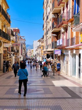 RONDA SPAIN - MAY 2022. Tourist walking in the shop street of Ronda in a sunny day. 