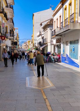 RONDA SPAIN - MAY 2022. Tourist walking in the shop street of Ronda in a sunny day. 