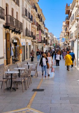 RONDA SPAIN - MAY 2022. Tourist walking in the shop street of Ronda in a sunny day. 