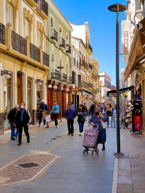 RONDA SPAIN - MAY 2022. Tourist walking in the shop street of Ronda in a sunny day. 