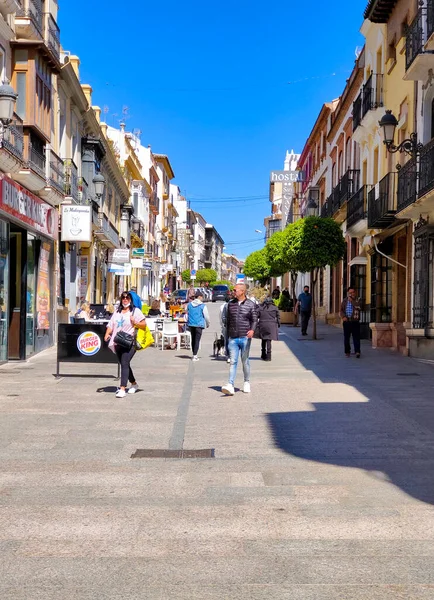 RONDA SPAIN - MAY 2022. Tourist walking in the shop street of Ronda in a sunny day. 