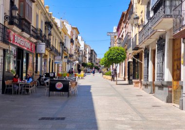 RONDA İSPA - Mayıs 2022. Güneşli bir günde Ronda 'nın alışveriş caddesinde bir turist. Malaga 'nın bir köyünde yürüyen insanları görebilirsiniz..