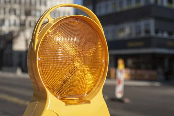 stock image close-up of the yellow reflector lamp at a warning sign in a city street