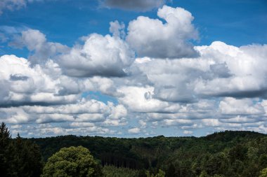 Güneşli bir yaz gününde Swabian alblerinde ormanlık bir vadide bulutlar