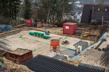 a construction site with plastic tubes in a gravel pit