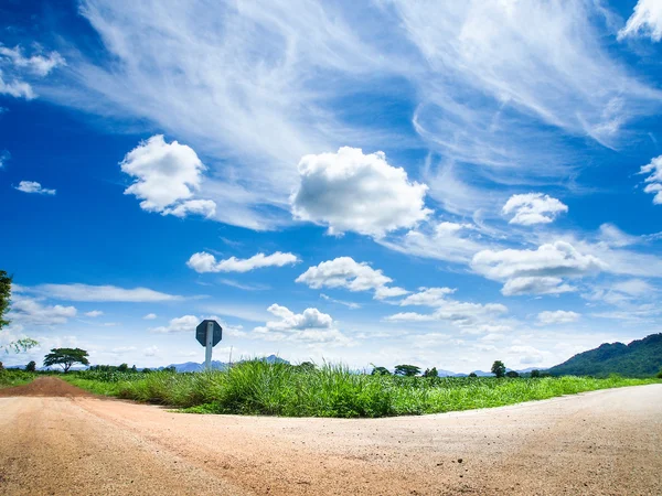 Rural crossroad green grass and blue sky — Stock Photo, Image