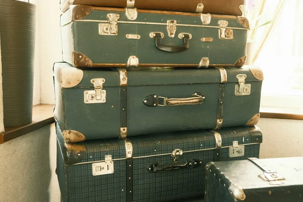 Old vintage travel suitcases. Set of various green and brown old suitcases. Nostalgia