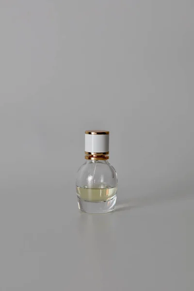 Perfume bottle on a white background. Cosmetics, perfumes, creams - product photography. Beautiful and neat bottle of perfume