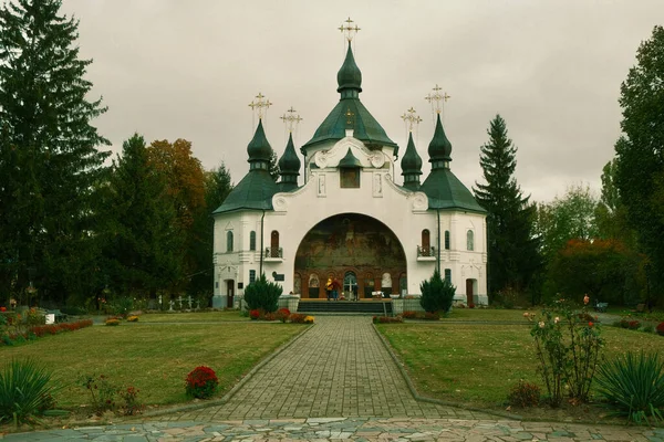 Ancient Cathedral. White wall of an old cathedral with windows and crosses. Ancient catholic cathedral and its crosses