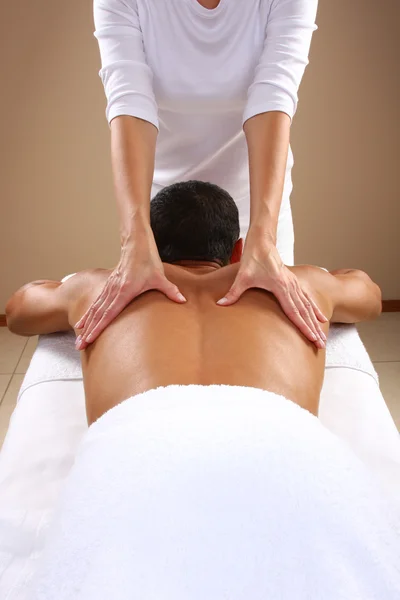 Young man receiving massage — Stock Photo, Image