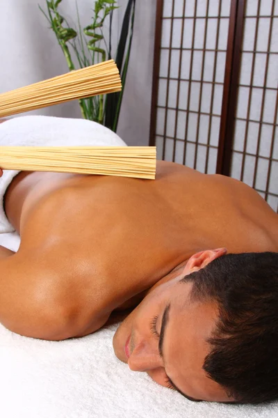 Young man receiving massage — Stock Photo, Image