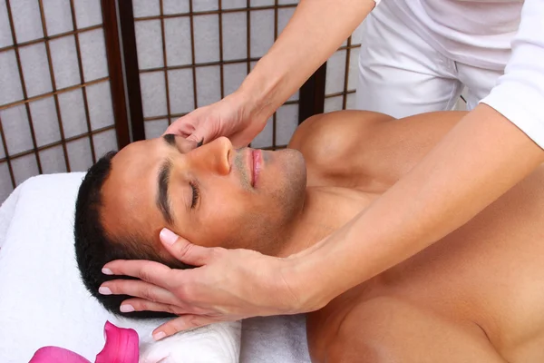 Young man receiving massage — Stock Photo, Image