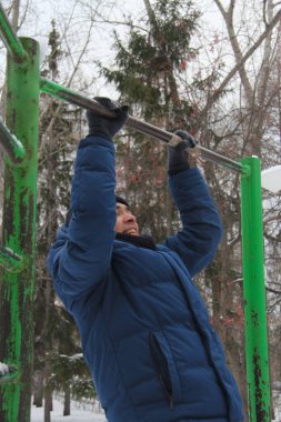 A guy performing a sporting activity on a street playground