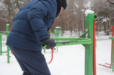 A guy performing a sporting activity on a street playground