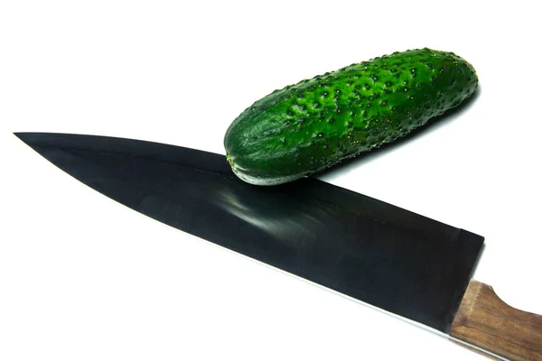 Isolated knife and cucumber on white background 