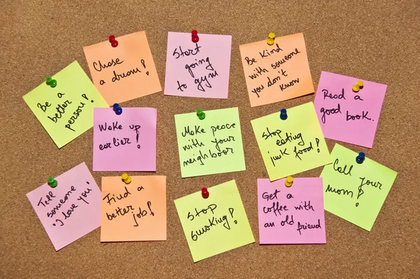 Een collectie van veelkleurige post-it notities met verschillende berichten op een houten achtergrond — Stockfoto