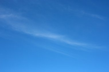 Small, barely visible clouds against the blue sky. Sky. clipart