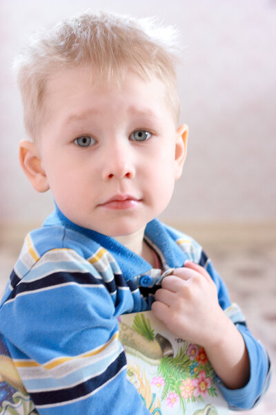 Young boy hold the book with pictures.