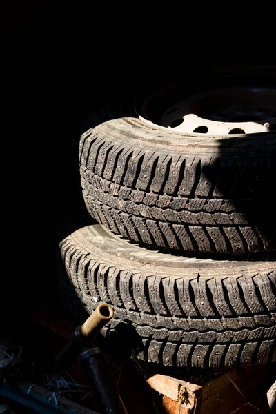 Two Car Wheels Lying Dark Garage — Zdjęcie stockowe