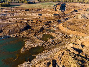 Panoramic aerial view of a large sand quarry, industrial landscape with mountains of sand