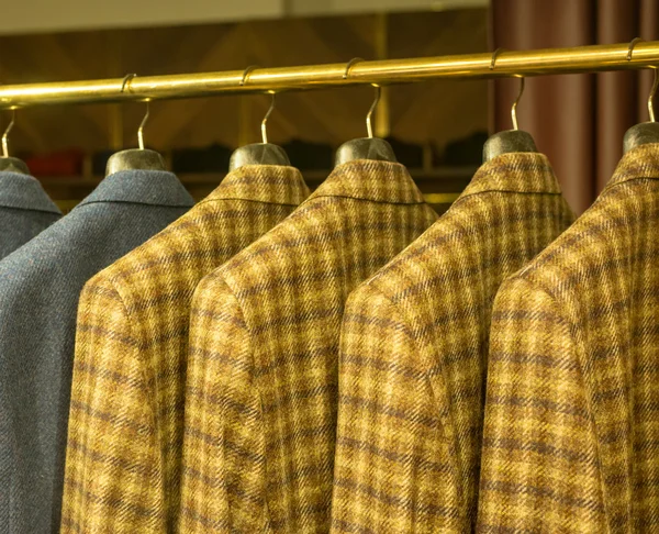 Yellow Checkered Suits on Rack — Stock Photo, Image