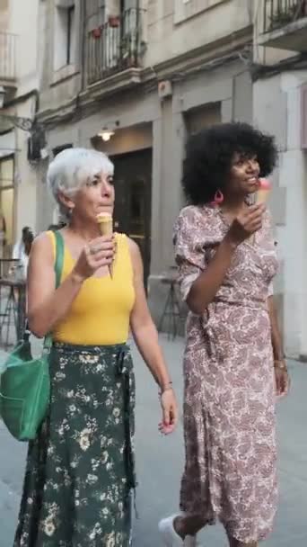 Happy Mature Female Friends Enjoying Eating Ice Cream While Walking — Video Stock