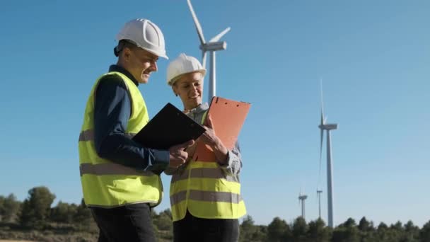 Two Engineers Inspecting Checking Wind Turbines While Working Together Field — Video Stock