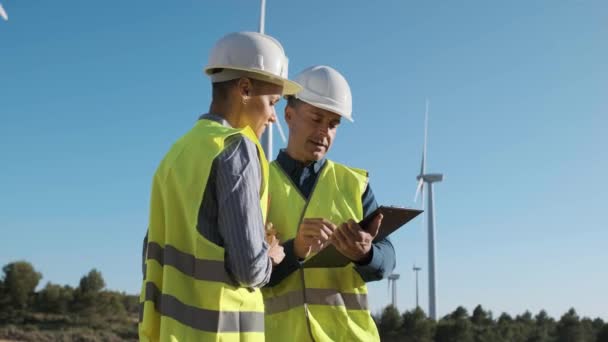 Two Engineers Discussing Project While Working Together Wind Farm Sustainable — Wideo stockowe