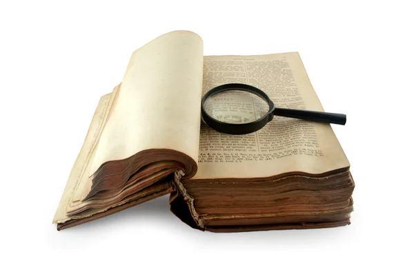 Old open Russian bible with a magnifying glass isolated on white — Stock Photo, Image