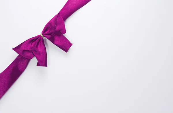 Purple ribbon with bow with tails isolated on white background — Stock Photo, Image